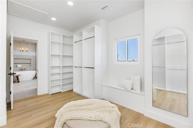 245 Surf Pl, Seal Beach, CA 90740 - walk in closet with wood finished floors and a chandelier