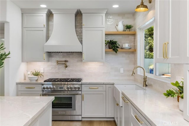 245 Surf Pl, Seal Beach, CA 90740 - kitchen featuring stainless steel range, custom exhaust hood, light stone countertops, decorative backsplash, and recessed lighting