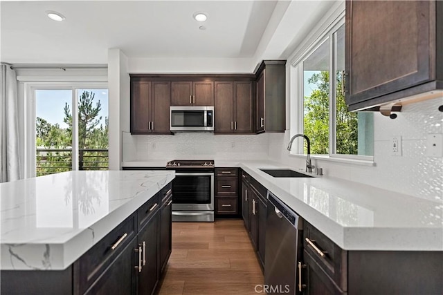 253 Steely, Irvine, CA 92614 - kitchen featuring stainless steel appliances, healthy amount of natural light, backsplash, dark wood-style floors, and recessed lighting
