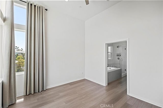 253 Steely, Irvine, CA 92614 - empty room featuring wood finished floors, ceiling fan, and high vaulted ceiling