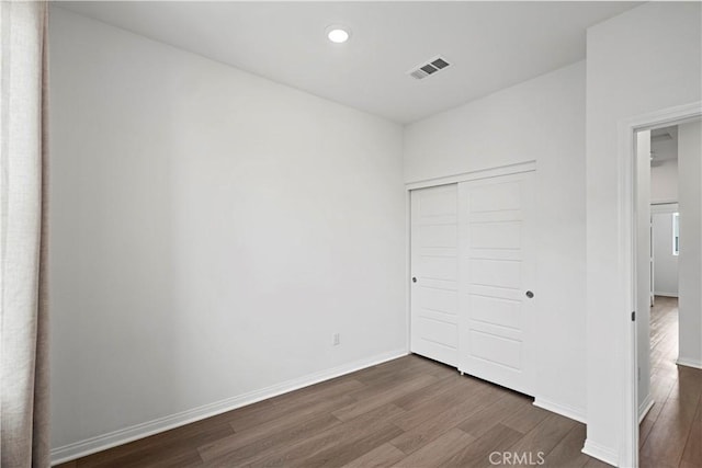 253 Steely, Irvine, CA 92614 - unfurnished bedroom with dark wood-style flooring, a closet, and recessed lighting
