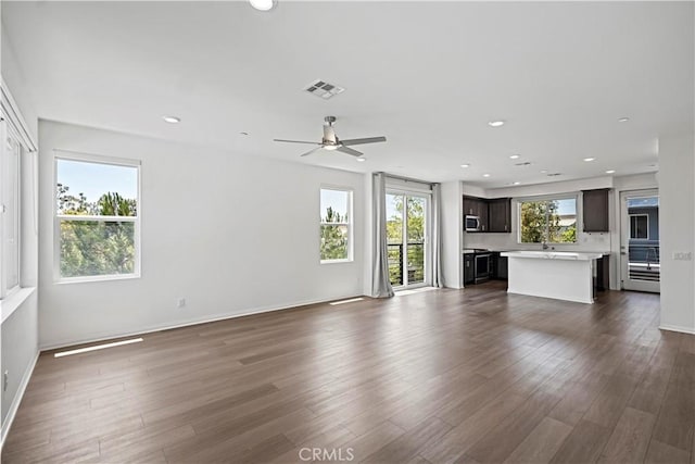 253 Steely, Irvine, CA 92614 - unfurnished living room with dark wood-type flooring, a ceiling fan, and recessed lighting