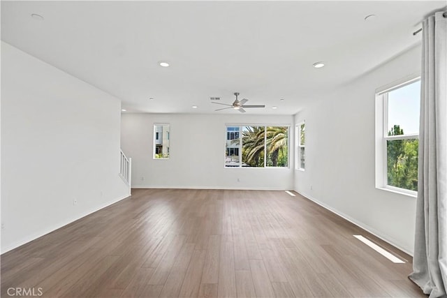 253 Steely, Irvine, CA 92614 - spare room featuring wood finished floors, stairs, ceiling fan, and recessed lighting