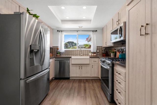 2046 Ups Cir, Oceanside, CA 92054 - kitchen with stainless steel appliances, dark countertops, dark wood-style flooring, tasteful backsplash, and a raised ceiling