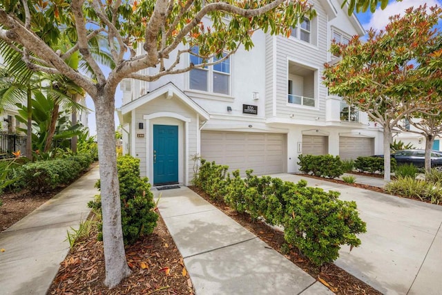 835 Harbor Cliff Way Unit 286, Oceanside, CA 92054 - view of property featuring stucco siding, an attached garage, and concrete driveway