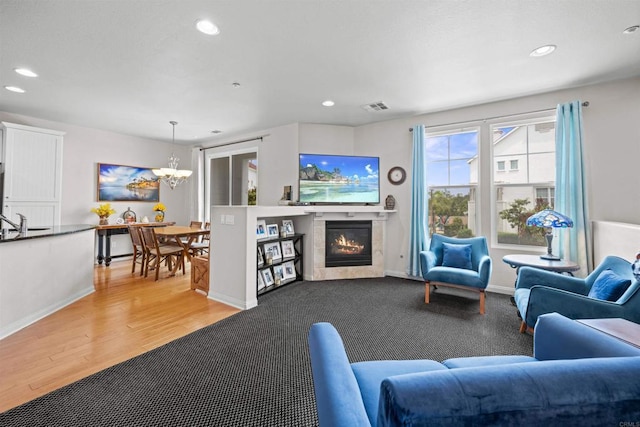 835 Harbor Cliff Way Unit 286, Oceanside, CA 92054 - living area with a chandelier, light wood-type flooring, recessed lighting, and a glass covered fireplace