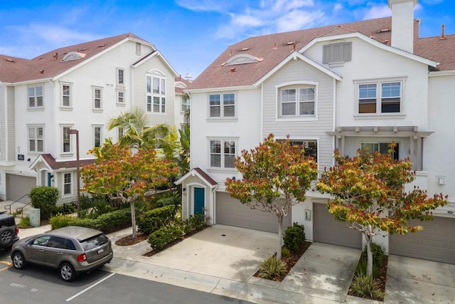 835 Harbor Cliff Way Unit 286, Oceanside, CA 92054 - townhome / multi-family property featuring a chimney, stucco siding, a garage, and concrete driveway