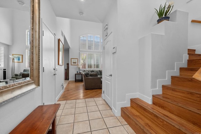 210 Belflora Way, Oceanside, CA 92057 - entryway with stairway, light tile patterned flooring, and a towering ceiling