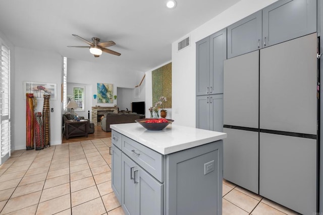 210 Belflora Way, Oceanside, CA 92057 - kitchen with freestanding refrigerator, gray cabinets, ceiling fan, light tile patterned floors, and light countertops