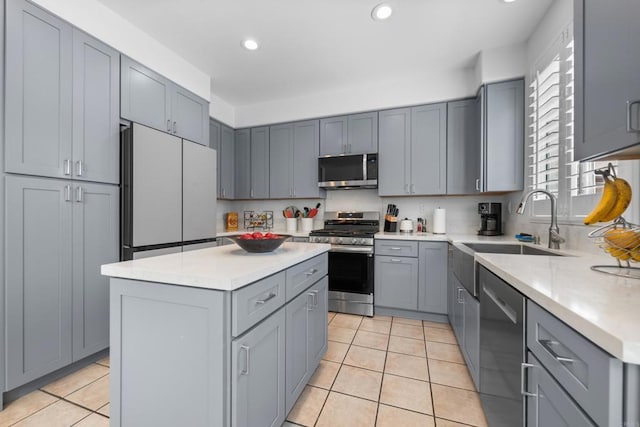 210 Belflora Way, Oceanside, CA 92057 - kitchen with stainless steel appliances, gray cabinets, a center island, light tile patterned floors, and recessed lighting