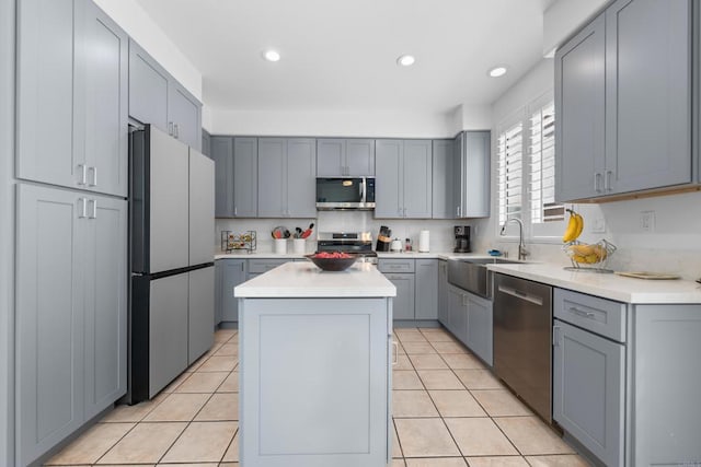 210 Belflora Way, Oceanside, CA 92057 - kitchen featuring stainless steel appliances, a center island, gray cabinets, light countertops, and light tile patterned floors