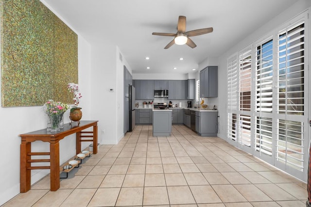 210 Belflora Way, Oceanside, CA 92057 - kitchen featuring gray cabinets, a ceiling fan, appliances with stainless steel finishes, a center island, and light countertops