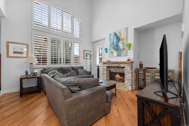 210 Belflora Way, Oceanside, CA 92057 - living room featuring a high ceiling, light wood-style floors, and a stone fireplace