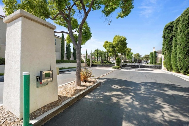 210 Belflora Way, Oceanside, CA 92057 - view of asphalt road featuring a gate, a gated entry, and curbs