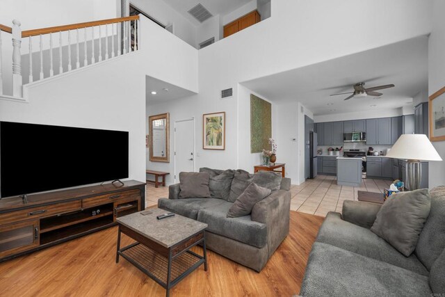 210 Belflora Way, Oceanside, CA 92057 - living room with ceiling fan, light wood-style floors, and a high ceiling