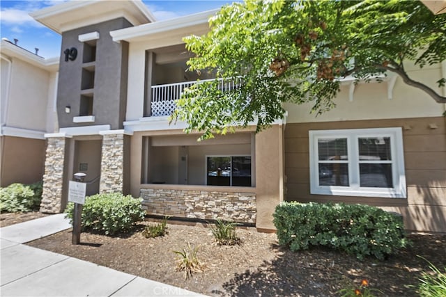 31387 Taylor Ln, Temecula, CA 92592 - view of front of property featuring stone siding, stucco siding, and a balcony