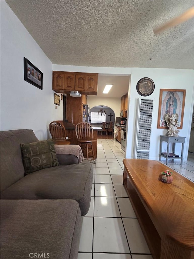 12157 Nava St, Norwalk, CA 90650 - living area featuring a heating unit, light tile patterned flooring, and a textured ceiling