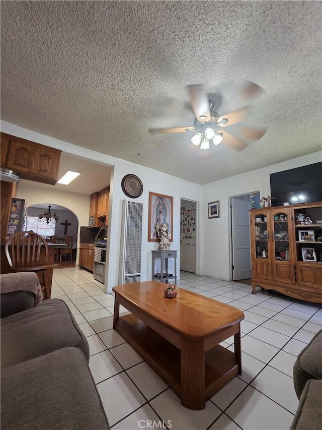 12157 Nava St, Norwalk, CA 90650 - living room featuring a heating unit, a ceiling fan, light tile patterned floors, a textured ceiling, and arched walkways