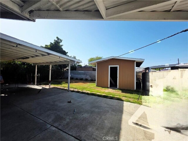 12157 Nava St, Norwalk, CA 90650 - view of patio / terrace with a storage shed and a carport