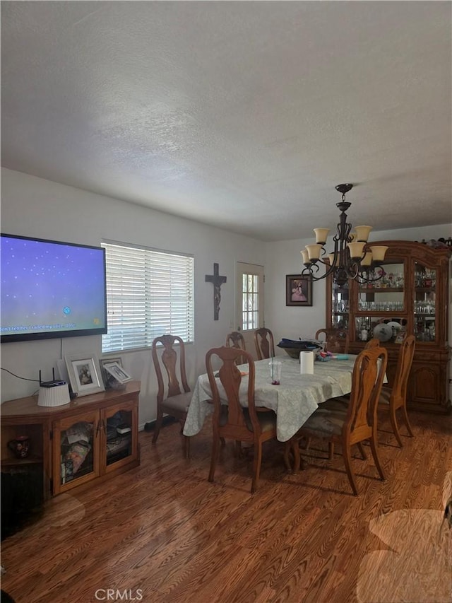 12157 Nava St, Norwalk, CA 90650 - dining room with wood finished floors, a chandelier, and a textured ceiling