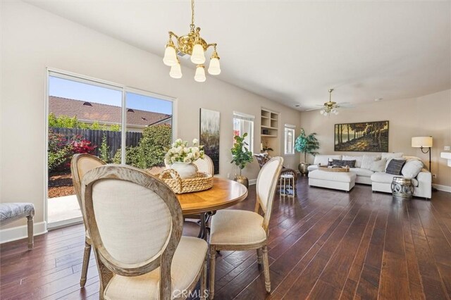1432 Blackberry Ave, Arroyo Grande, CA 93420 - dining space with a chandelier, dark wood-type flooring, a ceiling fan, and built in shelves