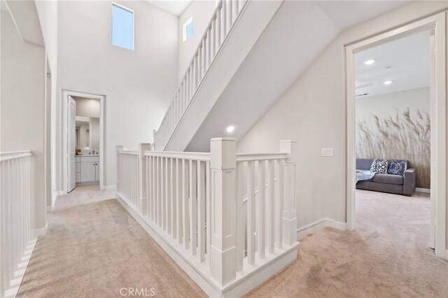 133 Denali, Lake Forest, CA 92630 - hall with carpet floors, a towering ceiling, and an upstairs landing