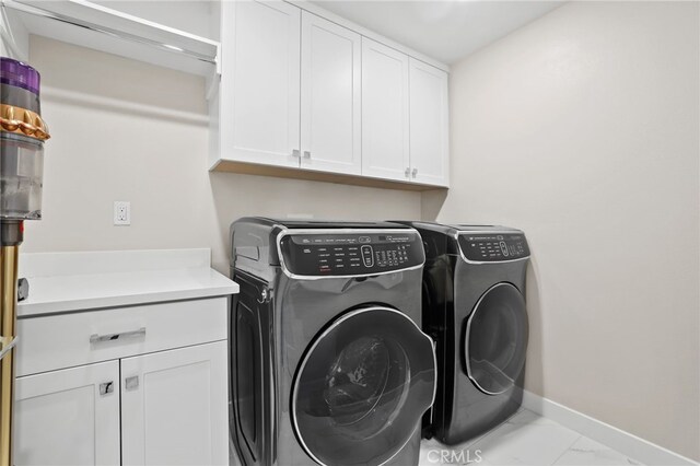 133 Denali, Lake Forest, CA 92630 - washroom featuring washing machine and clothes dryer, cabinet space, and marble look tile flooring
