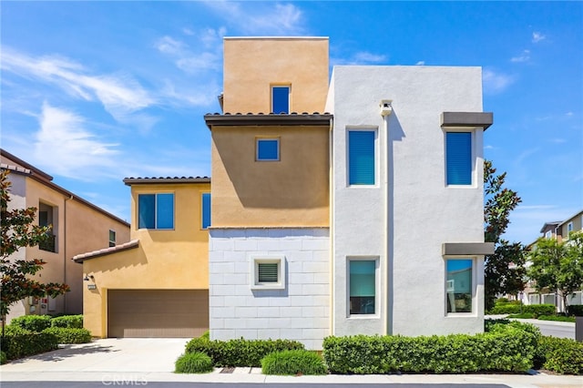 133 Denali, Lake Forest, CA 92630 - view of front facade with a garage, stucco siding, and concrete driveway