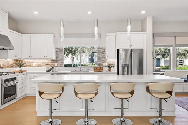 133 Denali, Lake Forest, CA 92630 - kitchen featuring stainless steel appliances, light countertops, backsplash, white cabinetry, and recessed lighting