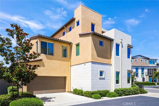 133 Denali, Lake Forest, CA 92630 - view of property with an attached garage, stucco siding, concrete driveway, and a tiled roof