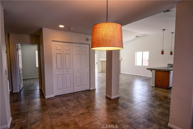 9464 Palm Dr, Desert Hot Springs, CA 92240 - empty room with dark tile patterned flooring, recessed lighting, and lofted ceiling