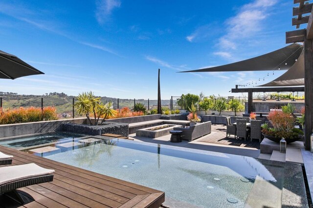 15614 S Chevy Chase, San Diego, CA 92127 - view of swimming pool featuring a fire pit, outdoor dining space, a pool with connected hot tub, and a wooden deck