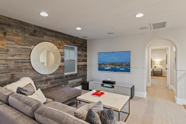 15614 S Chevy Chase, San Diego, CA 92127 - living room featuring arched walkways, wooden walls, recessed lighting, an accent wall, and carpet floors