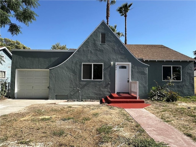 841 W 17th St, San Bernardino, CA 92405 - view of front facade with stucco siding, an attached garage, concrete driveway, and a shingled roof
