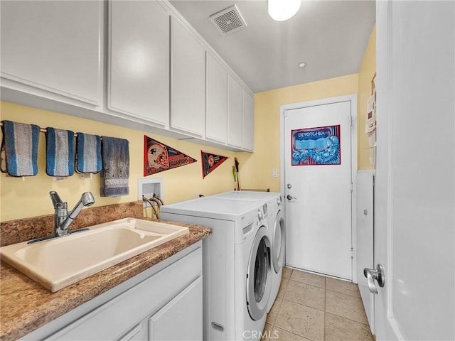 13906 Lexicon Ave, Sylmar, CA 91342 - laundry room with separate washer and dryer, light tile patterned flooring, and cabinet space
