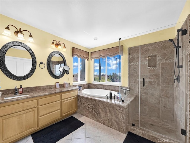 13906 Lexicon Ave, Sylmar, CA 91342 - bathroom featuring a bath, vanity, tile patterned flooring, and a stall shower