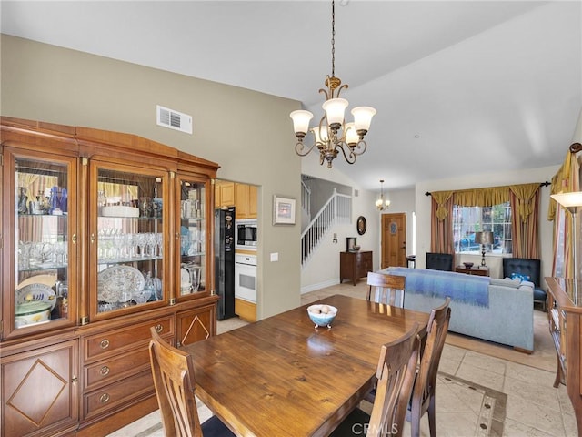13906 Lexicon Ave, Sylmar, CA 91342 - dining area with a chandelier, vaulted ceiling, stairs, and light tile patterned floors