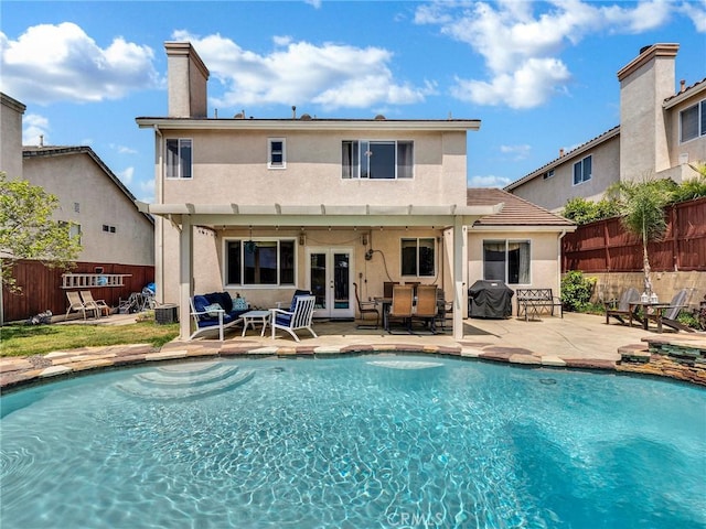 13906 Lexicon Ave, Sylmar, CA 91342 - back of house featuring french doors, stucco siding, an outdoor living space, a patio area, and a chimney