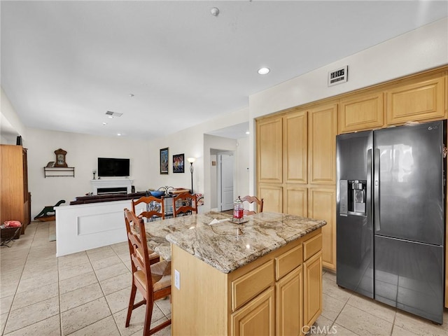13906 Lexicon Ave, Sylmar, CA 91342 - kitchen featuring refrigerator with ice dispenser, light tile patterned flooring, light stone counters, a kitchen island, and recessed lighting