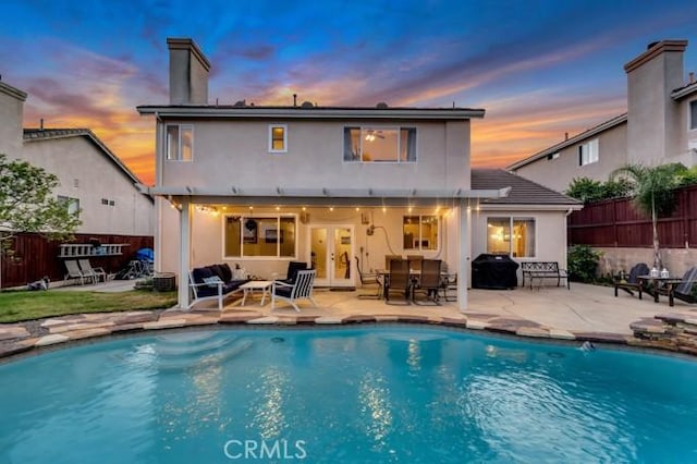 13906 Lexicon Ave, Sylmar, CA 91342 - rear view of house with a patio, french doors, stucco siding, and outdoor lounge area