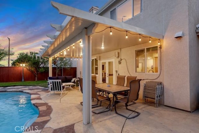 13906 Lexicon Ave, Sylmar, CA 91342 - patio terrace at dusk with a patio area, a fenced backyard, and an outdoor living space