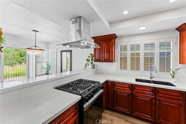 710 S Tourmaline Ct, Anaheim Hills, CA 92807 - kitchen with black gas stove, island exhaust hood, dark brown cabinets, light countertops, and light wood-type flooring