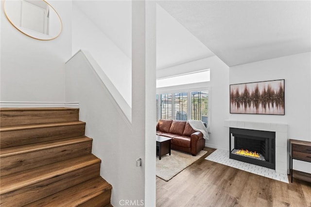 710 S Tourmaline Ct, Anaheim Hills, CA 92807 - stairs with wood finished floors and a tile fireplace