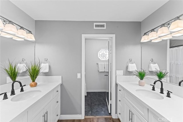 710 S Tourmaline Ct, Anaheim Hills, CA 92807 - bathroom featuring two vanities and wood finished floors
