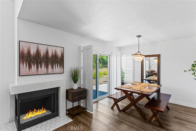 710 S Tourmaline Ct, Anaheim Hills, CA 92807 - dining room with wood finished floors, a tiled fireplace, and a chandelier