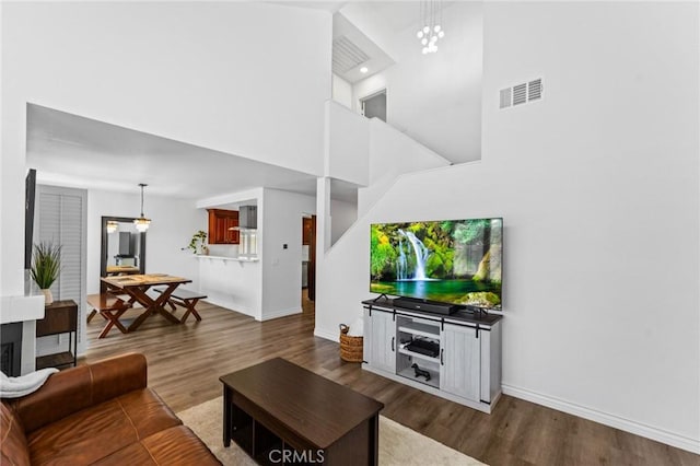 710 S Tourmaline Ct, Anaheim Hills, CA 92807 - living area with a high ceiling, dark wood-type flooring, and a chandelier