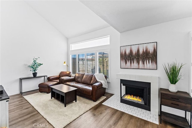 710 S Tourmaline Ct, Anaheim Hills, CA 92807 - living room with high vaulted ceiling, wood finished floors, and a tiled fireplace