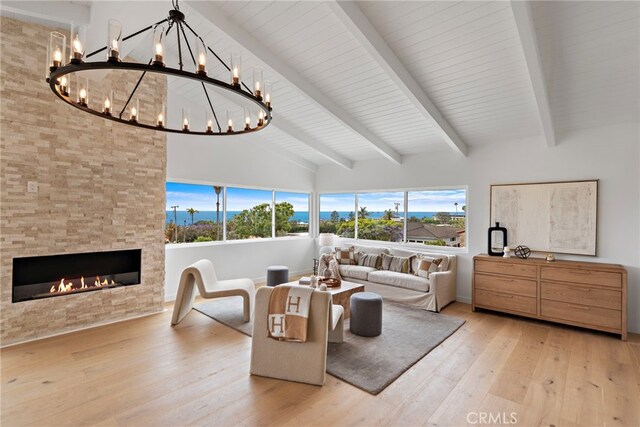 8 Clipper Rd, Rancho Palos Verdes, CA 90275 - living area featuring light wood-type flooring, a chandelier, high vaulted ceiling, beamed ceiling, and a large fireplace