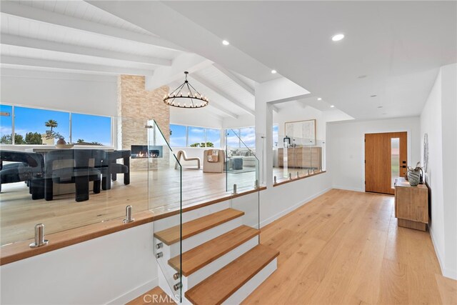 8 Clipper Rd, Rancho Palos Verdes, CA 90275 - stairs with a chandelier, wood finished floors, recessed lighting, and a stone fireplace