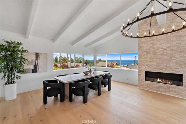 8 Clipper Rd, Rancho Palos Verdes, CA 90275 - dining room featuring a chandelier, beamed ceiling, wood finished floors, a fireplace, and high vaulted ceiling